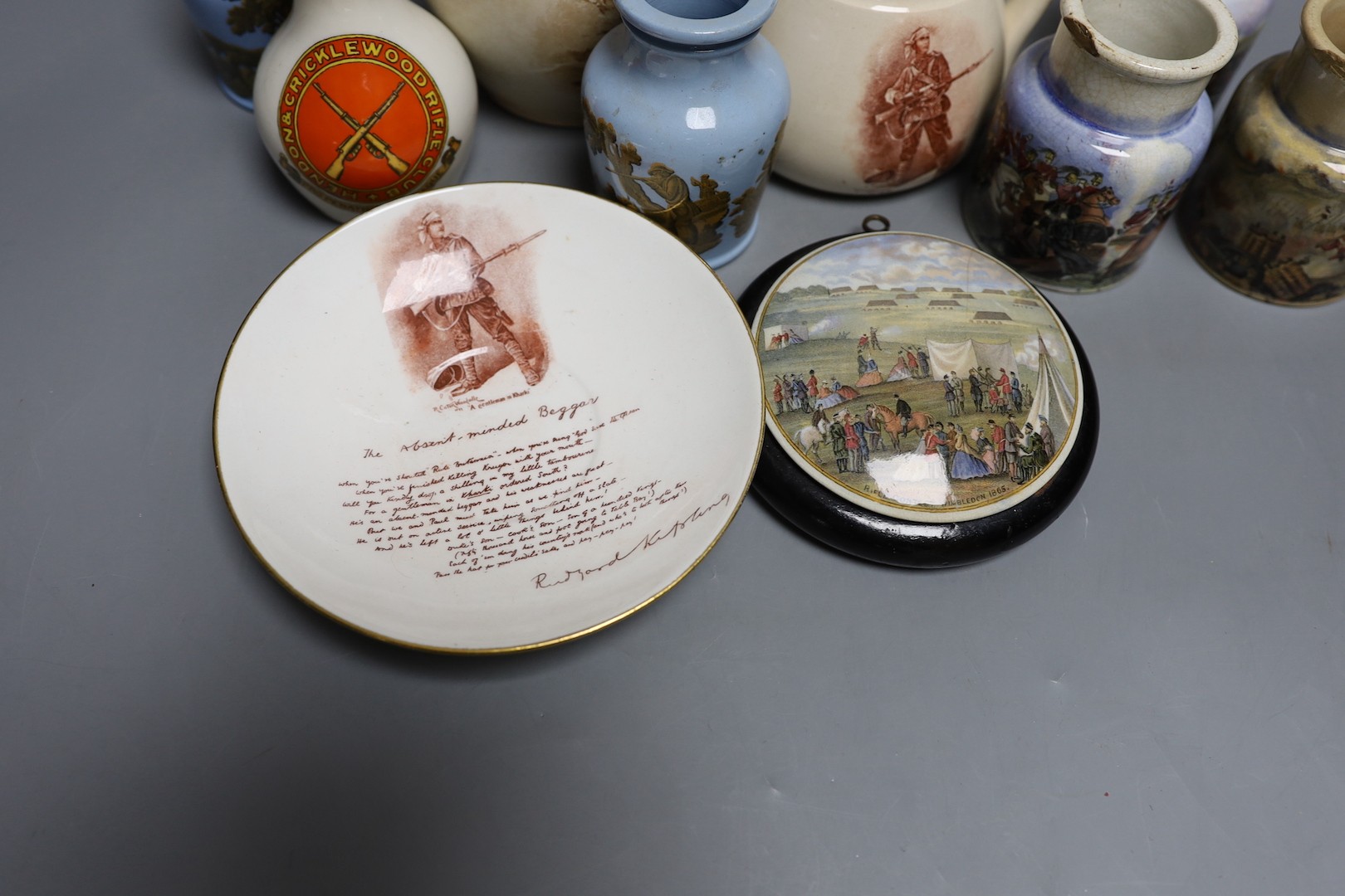 Crimean, Boer war, WWI and shooting commemorative ceramics - including Pratt ware pots, a gentleman in khaki jug and saucer, a rifle contest Wimbledon 1865 pot lid, a Goss Hendon and Cricklewood rifle club vase etc.